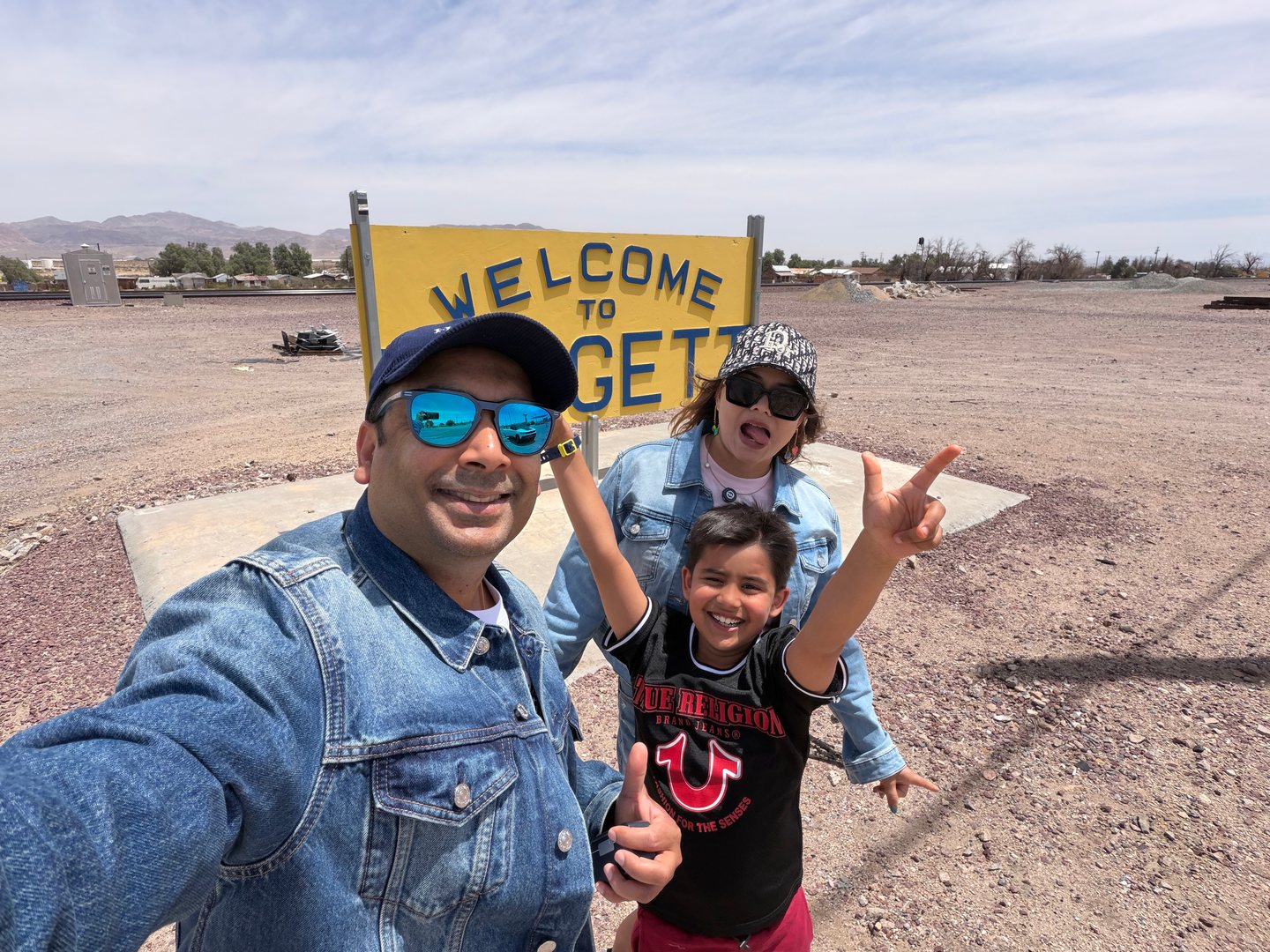 Our family enjoying a roadside stop in an open desert landscape.